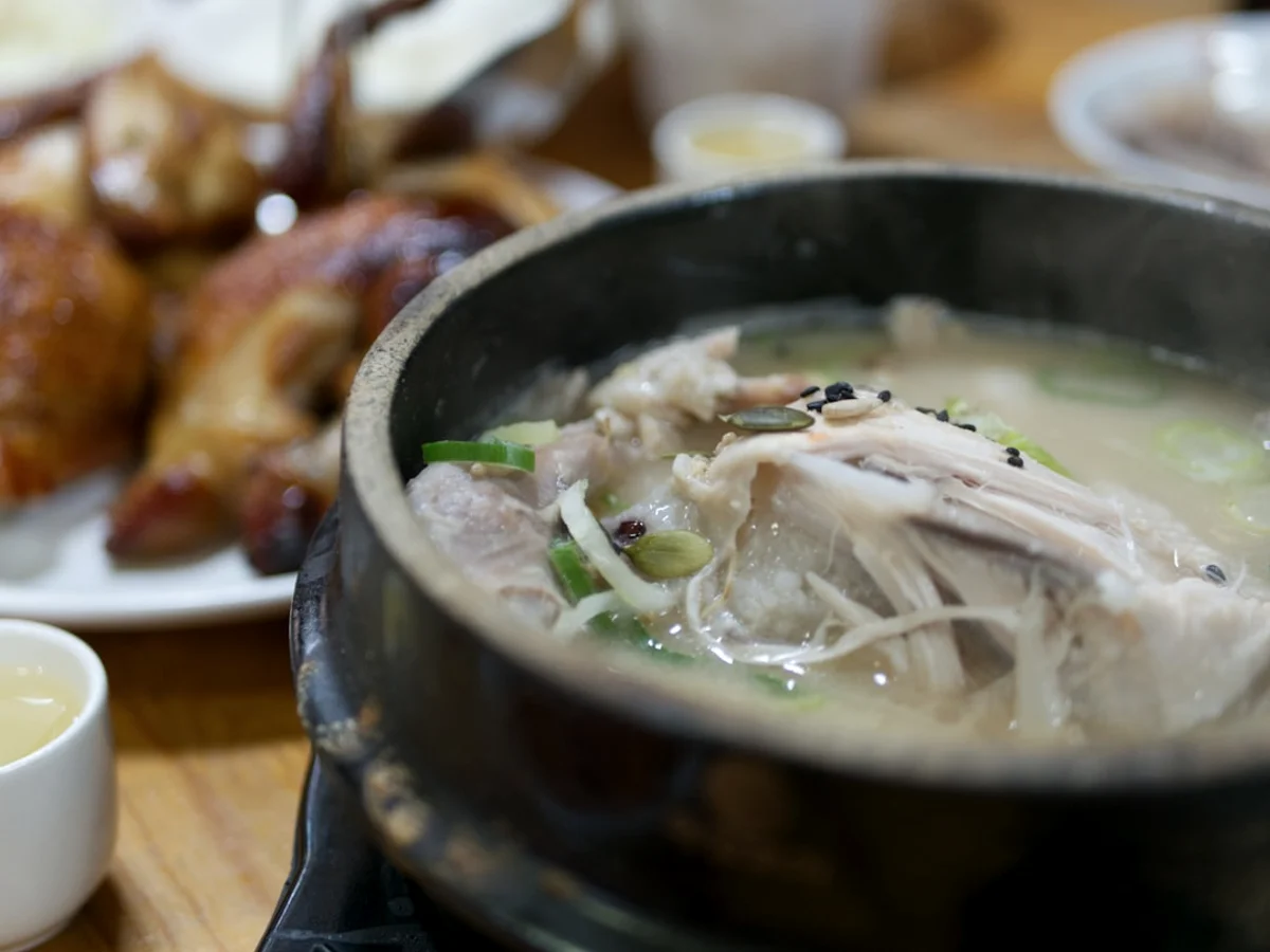 White soup on black ceramic pot related to Learn how to navigate in Korea